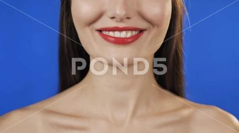 Happy girl holds a doughnut and bites one of them, slow motion woman eat donut Stock Photos