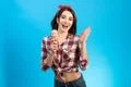 The happy girl with an ice cream on the blue background Photo