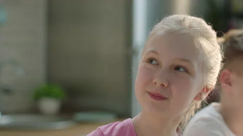 Happy girl laughing while having breakfast with her family Stock Footage 196704859