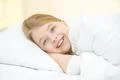 The happy girl lay on the bed Photo