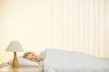 The happy girl lie on the bed Photo