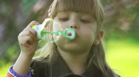 Happy girl playing with bubbles Stock Footage 10931338