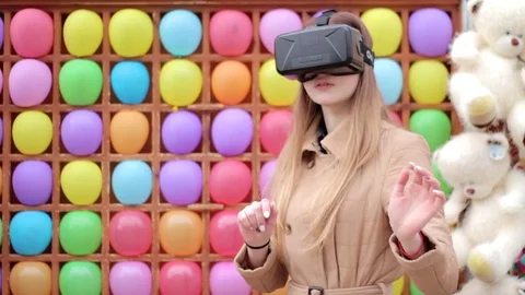 Happy girl playing having fun wearing vr virtual reality set colorful background Stock Footage