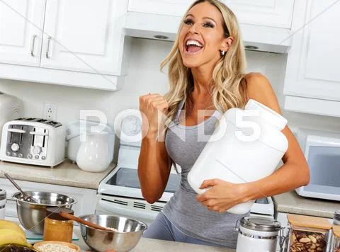 Happy girl with protein jar. Stock Photos