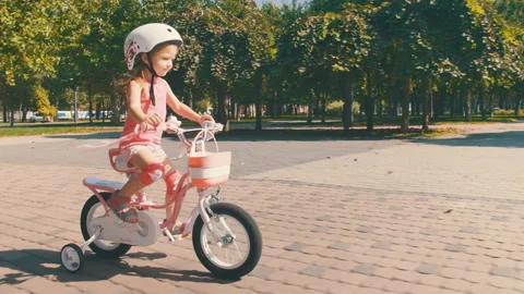 Happy Girl in Safety Helmet Riding a Bike in Park Stock Footage