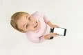 The happy girl stand with a smartphone. View from above Photo