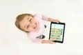 The happy girl stand with a tablet. View from above Photo