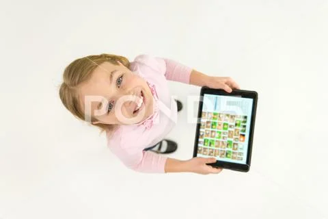 The happy girl stand with a tablet. View from above Stock Photos