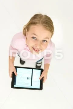 The happy girl stand with a tablet. View from above Stock Photos