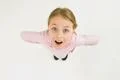 The happy girl stand on the white background. View from above Photo