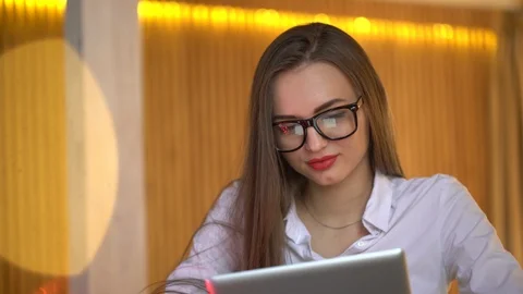 Happy girl using her new laptop in the office and browsing internet on it, 4 k Stock Footage 85649448