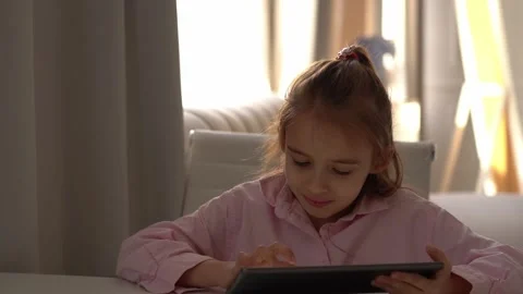 Happy Girl Using Tablet. Intensely focused on a gadget Stock Footage 280407781