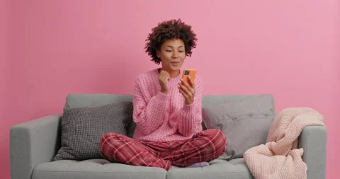 Happy girlfriend makes video call to boyfriend sends air kiss at smartphone Stock Footage 144064161