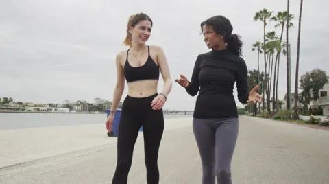 Happy girlfriends walking after their run Stock Footage