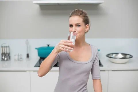 Happy gorgeous model looking at camera drinking glass of milk Stock Photos