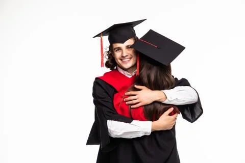 Happy graduated young students couple hugging isolated on white background Stock Photos