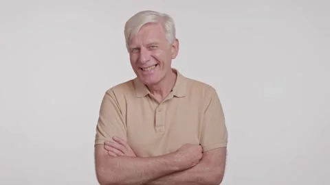Happy gray haired man looking at camera and crossing arms .laugh. studio shot Stock Footage 262016706