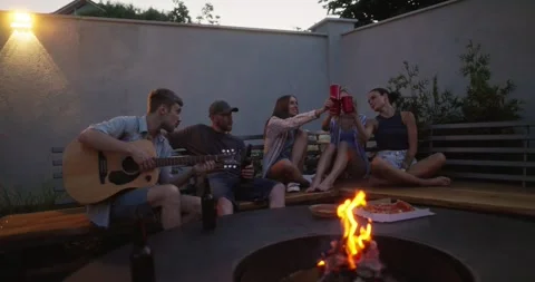 Happy group of five young adults chatting and having fun during their party near Video stock 285698439