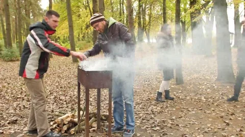 Happy group of friends having fun at outdoor bbq barbecue in the autumn forest Vídeo Stock 69157954
