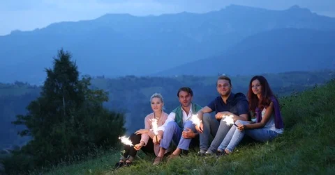 Happy Group of Friends Having Fun Smile Mountain Party Lighting Sparklers Night Stock Footage 83403608