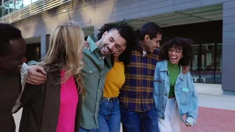 Happy group of friends laughing while walking together at city street Stock Footage 278858974