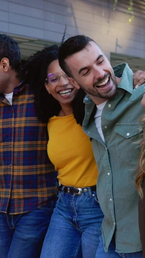 Happy group of friends laughing while walking together at city street Stock Footage 288074614
