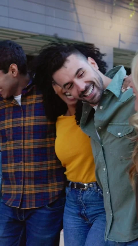 Happy group of friends laughing while walking together at city street Stock Footage 289435689