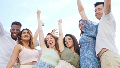 Happy group of friends raising the arms while smiling Stock Footage 199183853