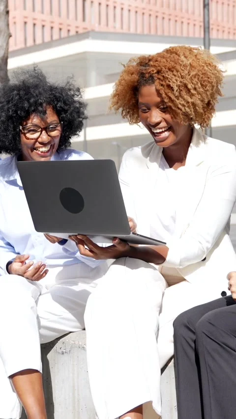 Happy group of multi-ethnic business people using laptop outdoors Stock Footage 256287300