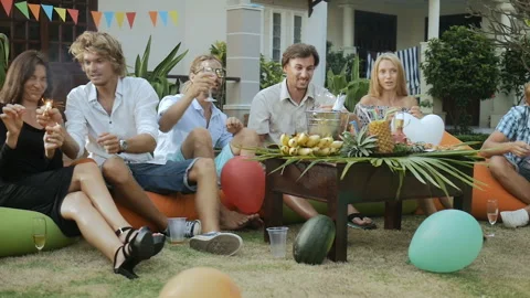 Happy group of people having fun, smiling, lighting sparklers Stock Footage 93422975
