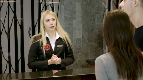 Happy guests returning the key to room to the receptionist at reception area. 4K Video stock 89260154