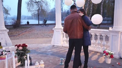 Happy guy and girl embrace and dance in the park. Romantic date Stock Footage