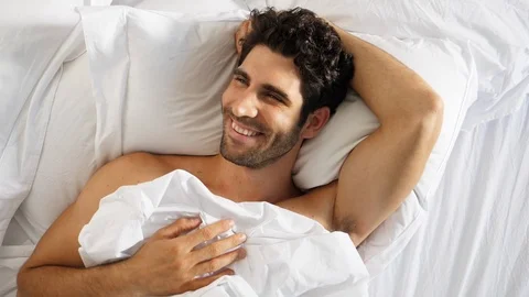 Happy guy in bed 스톡 동영상 89463793