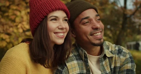 Happy guy with Black skin and stubble sits with his girlfriend and enjoys the Stock Footage 299924997