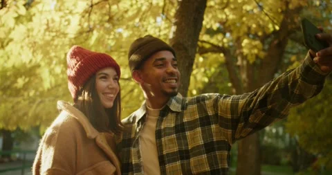 A happy guy with Black skin in a checkered shirt takes a selfie with his Stock Footage 299924888