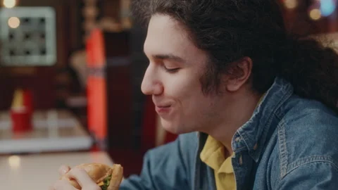 Happy Guy Devouring Cheeseburger and Enjoying Life Stock Footage 276608839