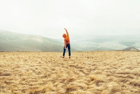 Happy guy jumping on meadow Stock Photos