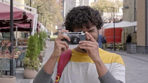 Happy guy with photo camera taking pictures at the street. Stock Footage 163282477