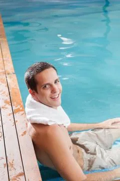 Happy guy relax inside the pool Stock Photos