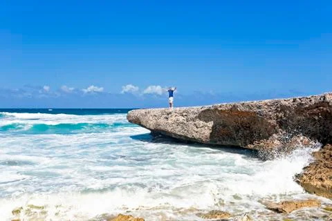 Happy guy on the rocks on aruba island in the caribbean Stock Photos
