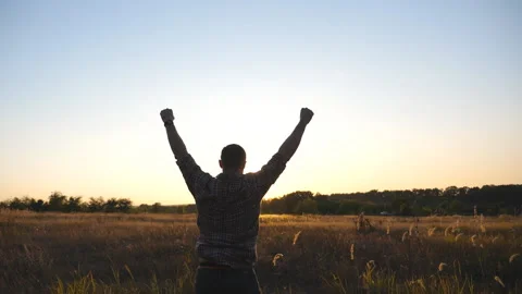 Happy guy running through grass field and victoriously raising hands up Vídeos de archivo 168481064