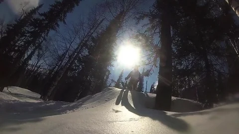 Happy guy on a skiing sliding down the slope at sunny day 動画素材 74630544