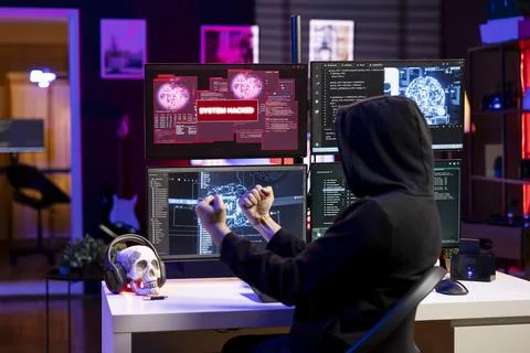 Happy hacker doing covert operations celebrates after bypassing security Stock Photos