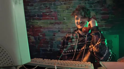 Happy Hacker or Programmer Answering Phone Call in Front of Vintage PC Computer Stock Footage 301319278
