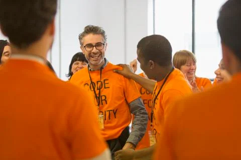Happy hackers coding for charity at hackathon Stock Photos
