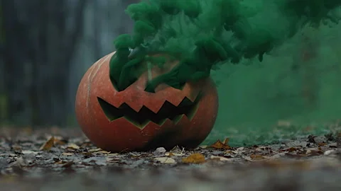 Happy Halloween, Jack o lantern in green smoke smiling in twilight autumn forest Stock Footage 212892830