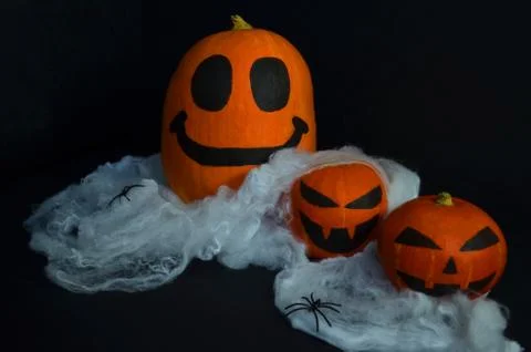 Happy Halloween pumpkin on the web with spiders. Stock Photos