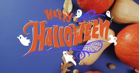 Happy Halloween text image over autumn leaves and pumpkins on blue background Ilustração Stock