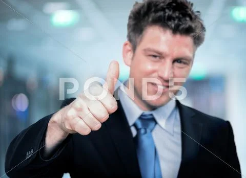 Happy handsome business man holding thumbs up Stock Photos