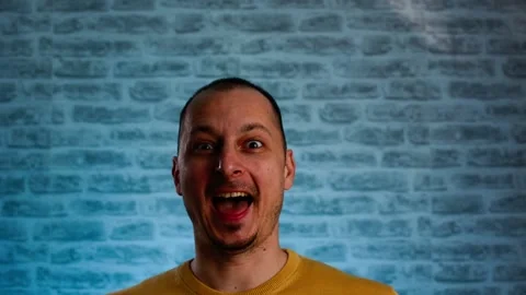 Happy Handsome guy surprised to camera over neon blue background. Video stock 147948277